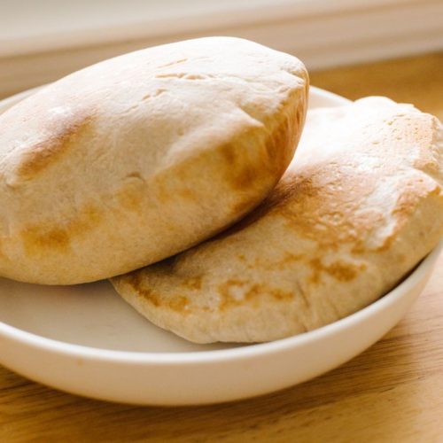 two pita breads in a white plate